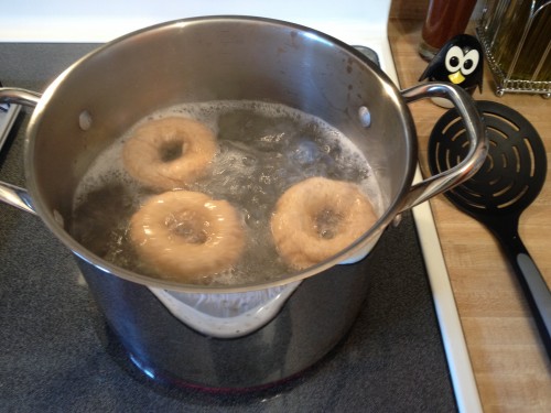 Boil bagels in water.