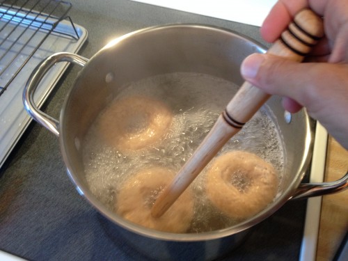 Flip bagels in boiling water