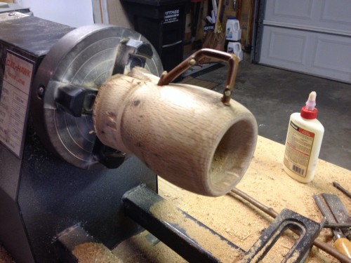 Adding a wooden handle to the oak coffee mug.