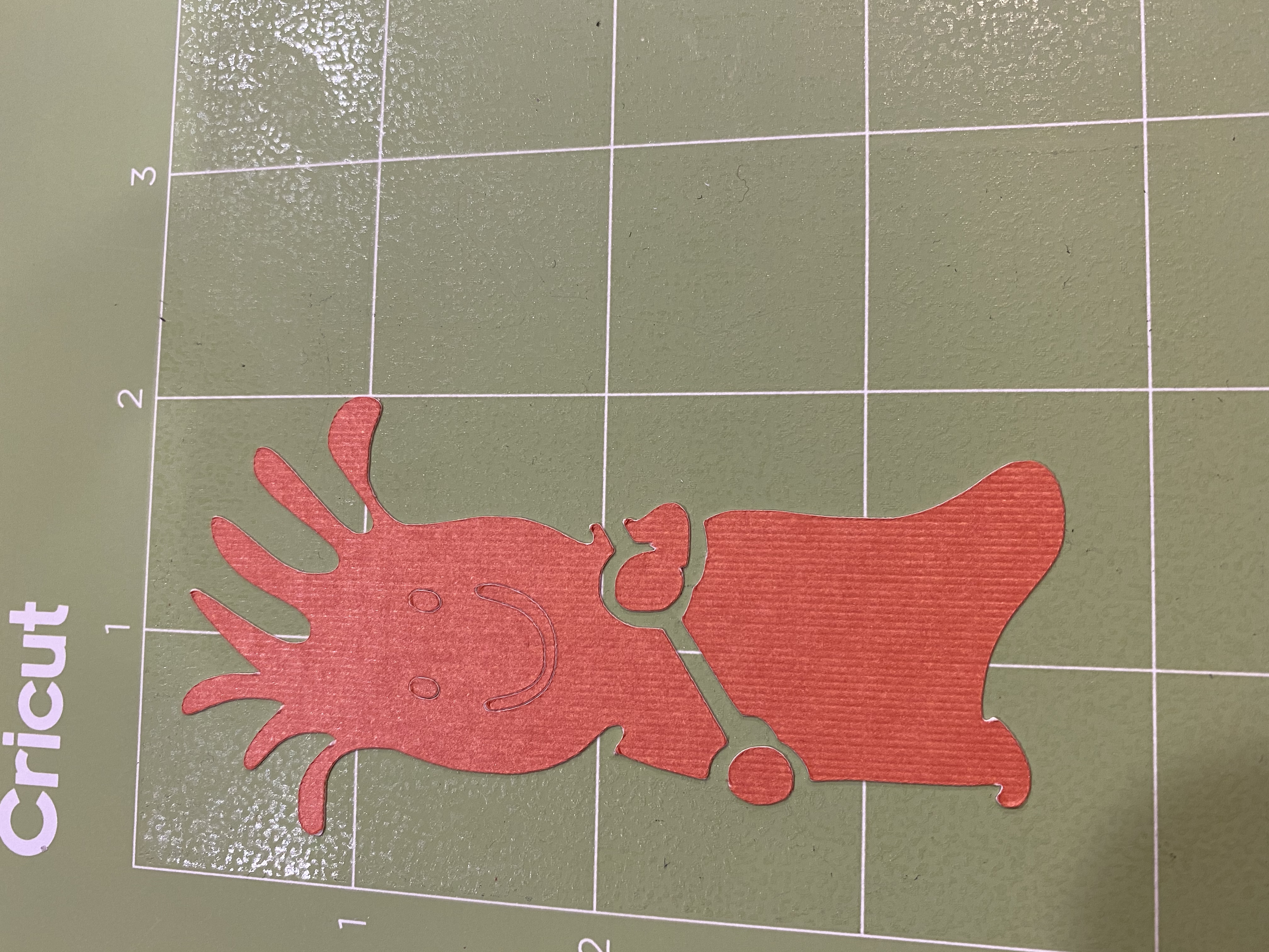 Mr, Chili orange body cut out on the Cricut mat