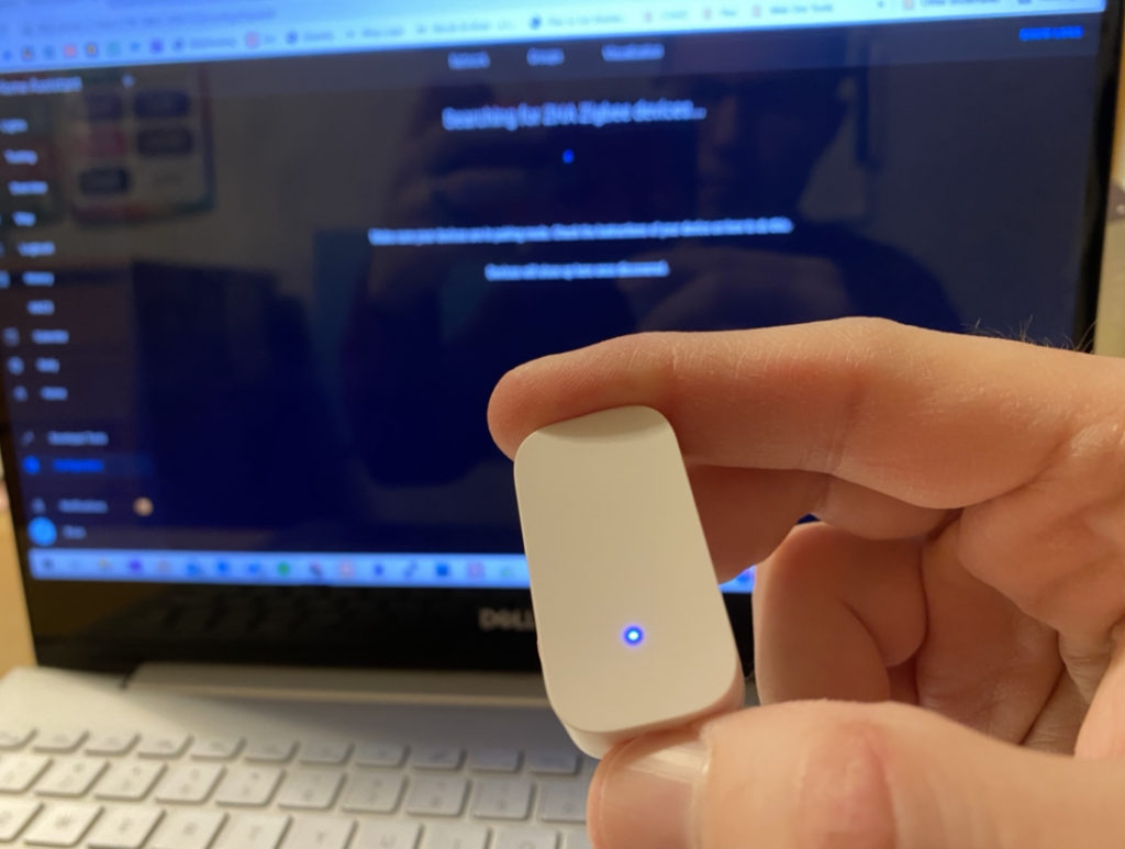 Press and hold the pair button on the Aqara contact sensor for 3 seconds